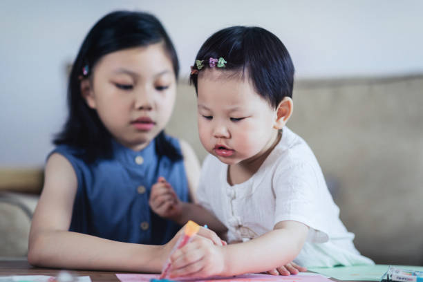 istock Little sisters enjoying drawing together 1166392898