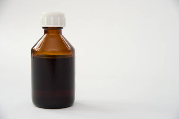 This image shows an amber glass dropper bottle with a black cap and dropper.