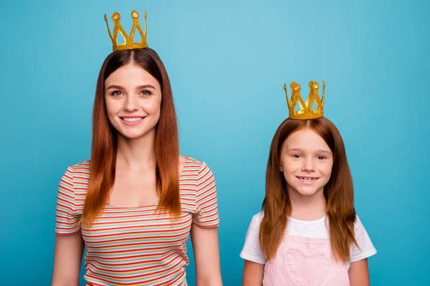 confident attractive little lady and mommy magic headwear dressed in casual outfit isolated blue background - real people blue white friendship imagens e fotografias de stock