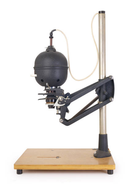 Vintage photo enlarger for photo negatives, isolated on white background. Side view of a vintage photo enlarger for projecting photo negatives, isolated on completely white background. Contains clipping path. photographic enlarger stock pictures, royalty-free photos & images