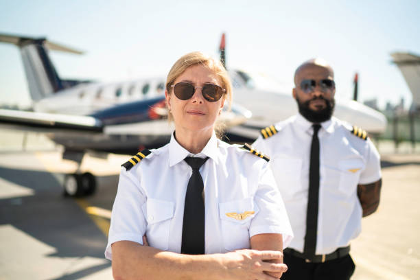 istock Two airplane pilots in a hangar and looking at camera 1166397870