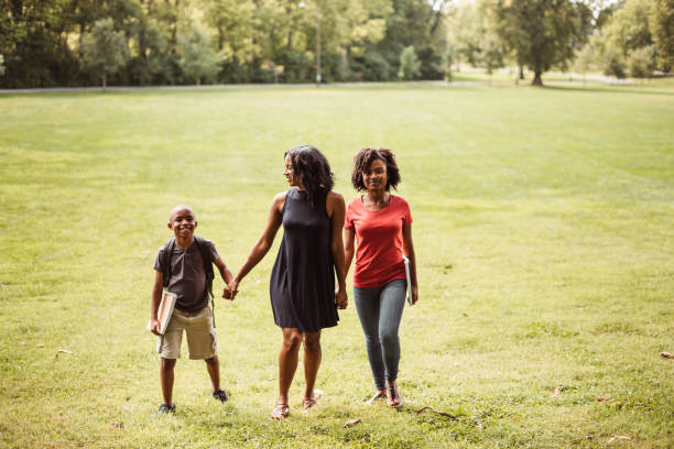 istock teacher with students in the park 1166398238