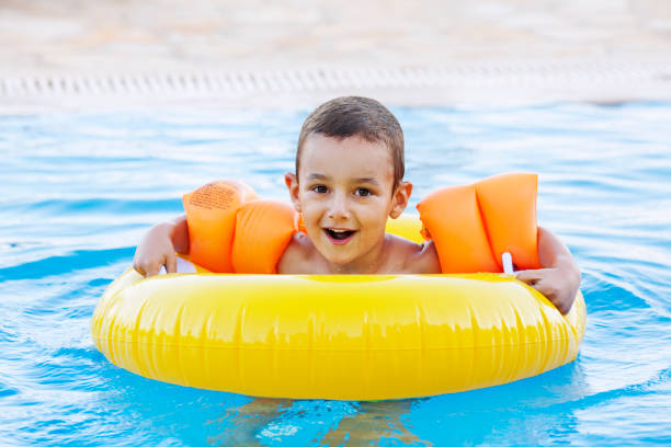 istock Cheerful boy in the swimming pool 1166398551