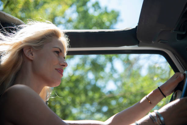 istock Woman driver On Road Trip In Convertible Car 1166399521
