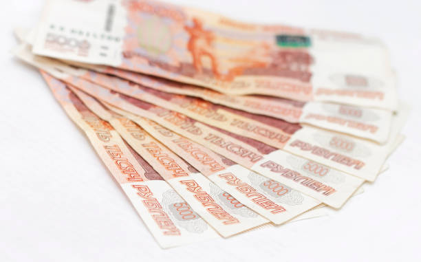 istock Scattered Russian 5000 rubles banknotes closeup isolated on the white background 1166399657