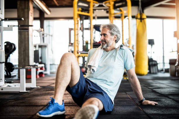 istock Mature man resting from exercise in a gym. 1166399952