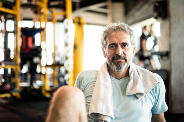istock Mature man resting from exercise in a gym. 1166401120