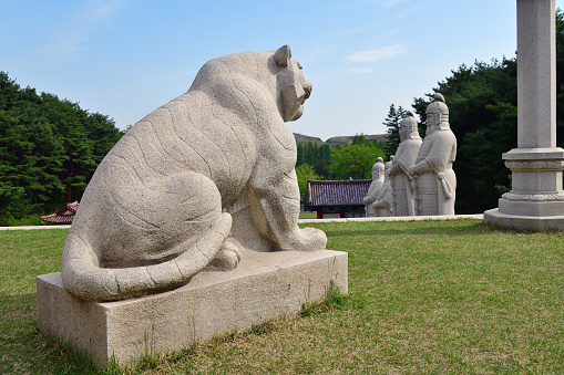 Kaesong, North Korea - May 5, 2019: Granite lion sculpture near Tomb of King Wanggon the founder of the Koryo dynasty. Modern replica