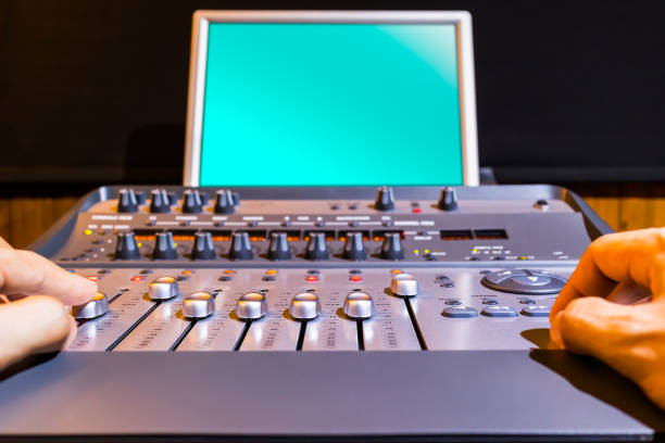 istock digital audio mixing board and blue blank display in broadcasting, recording studio 1166402954
