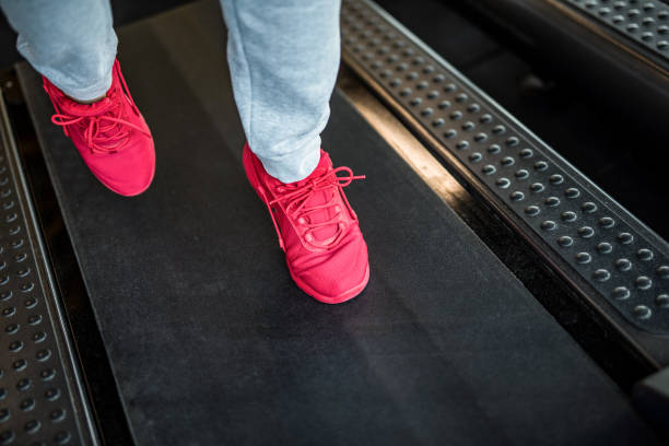 istock Mature man running on a treadmill feet close up. 1166402992