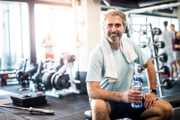 istock Mature man taking a break from exercise in a health club. 1166403130