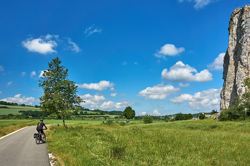 Dollnstein, Germany - June 17, 2019: Cyclists ride on a bike path through the Altmühltal near Dollnstein near Eichstätt.
