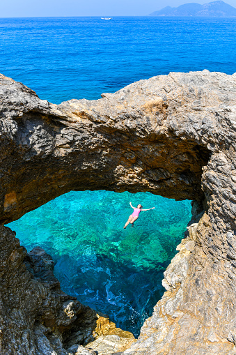 Woman floating in hole in the bay.