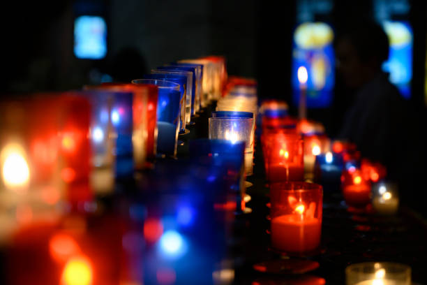 Candle lights burning inside coloured glass lanterns.