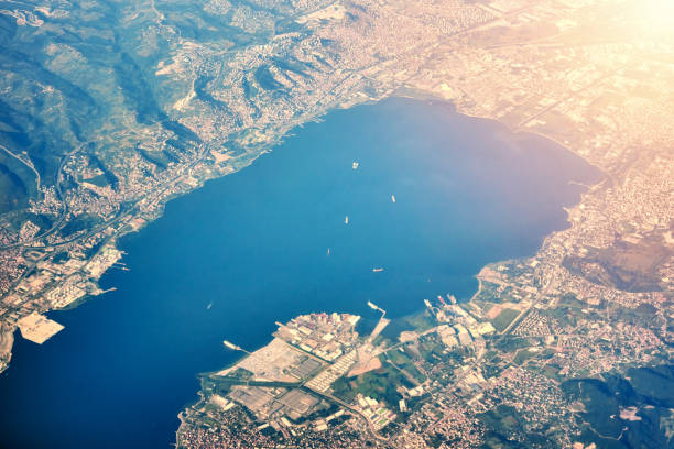 istock View from airplane, city in a mountain and coast 1166405917