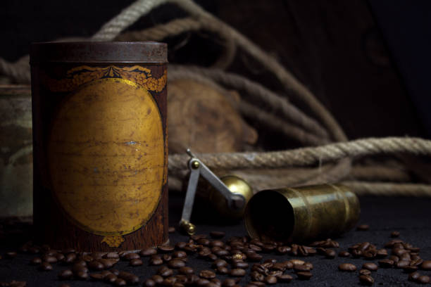 Vintage Rusted Coffee Tin Canister and Grinder With Coffee Beans On a Rustic Background