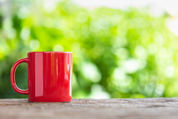 istock Red ceramic coffee cup on wooden table 1166406688