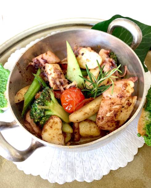 istock octopus with potatoes, broccoli, tomato and rosemary 1166406819