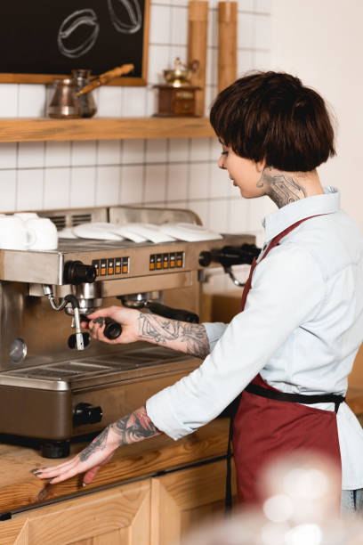 istock selective focus of pretty barista preparing coffee on espresso machine 1166407039