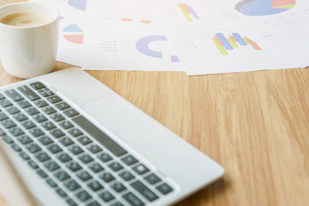 istock Graph on the desk analysis and laptop with business 1166407116