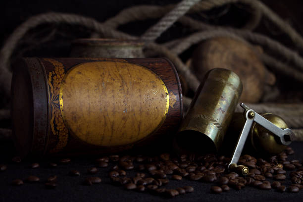 Vintage Rusted Coffee Tin Canister and Grinder With Coffee Beans On a Rustic Background