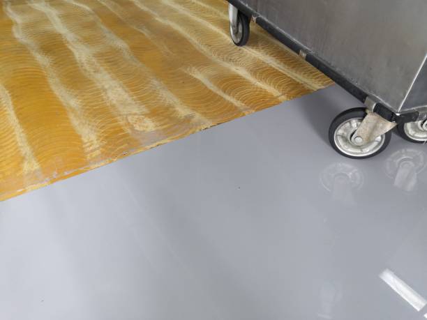 istock Renovation,self-leveling epoxy floor at Nutrition department.Spreading self leveling compound with trowel.Self-leveling epoxy. Leveling with a mixture of cement floors. 1166408647