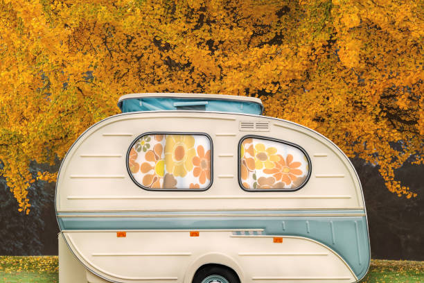 istock Vintage seventies white caravan with flower curtains in front of 1166409164