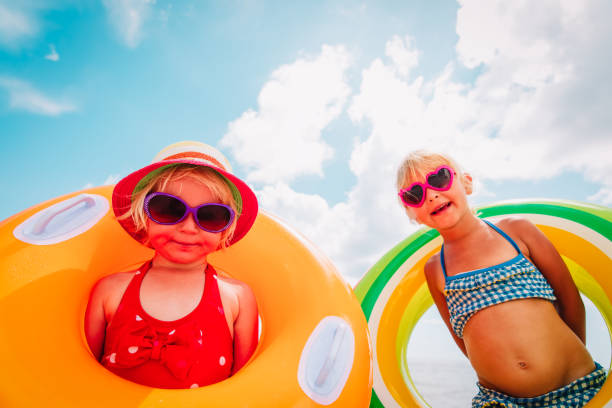 istock happy cute little girls with floaties at tropical beach 1166410185