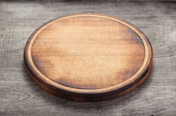 pizza cutting board at rustic wooden table plank