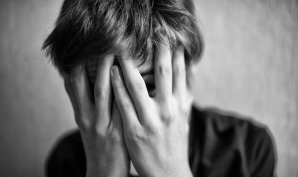 istock Teen boy covers his face with his hands 1166413029