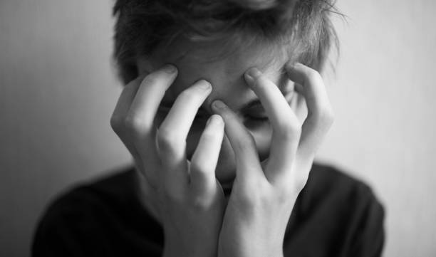 istock Teen boy covers his face with his hands 1166413037