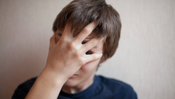 istock Teen boy covers his face with his hands 1166413048