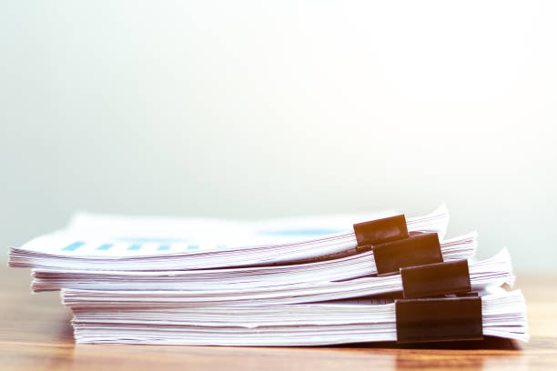 istock Stack of documents placed on a business desk in a business office. 1166413485