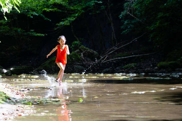 Girl playing in a mountain stream