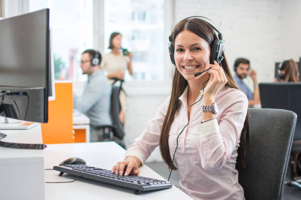 istock Positive female customer services agent with headset working in call center 1166416208