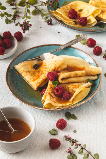 Suzette Crepe Citrus Sauce and Rum and Raspberries for Chandeleur Crêpe Suzette Citrus Sauce and Rum and Raspberries for Candlemas candlemas stock pictures, royalty-free photos & images