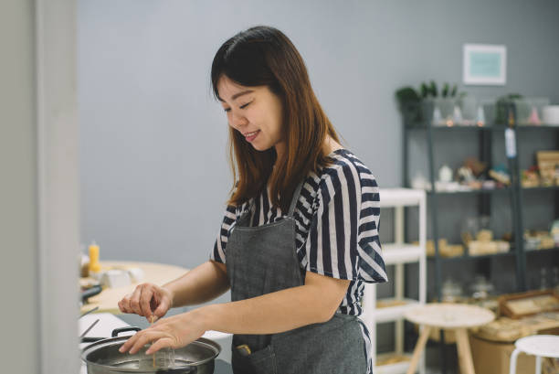 istock An asian chinese female boiling soy wax mixture 1166416901