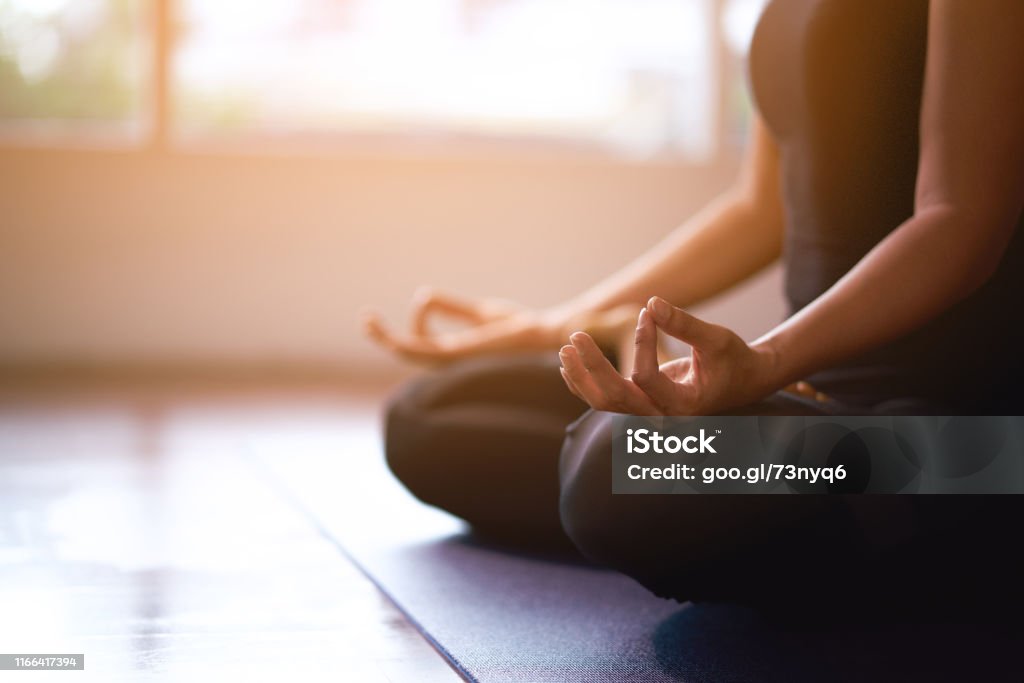 Women in meditation while practicing yoga in a training room. Happy, calm and relaxing. Yoga Stock Photo