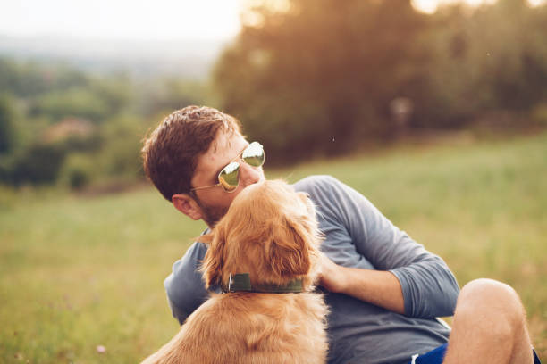 istock Guy and his dog having a fun in the nature 1166419016