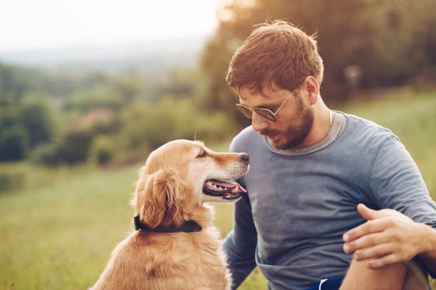 istock Guy and his dog having a fun in the nature 1166420928