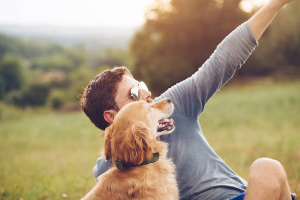 istock Guy and his dog having a fun in the nature 1166421157