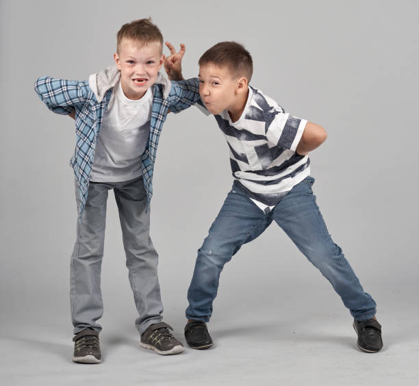 istock Two Boys Are Fooling Around Who Making Funny Face Better 1166421199