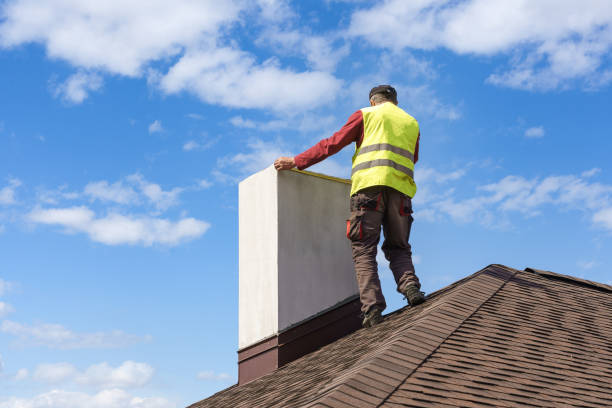 Man measuring chimney on roof top of new house under construction Professional workman standing roof top and measuring chimney of new house under construction against blue background chimney stock pictures, royalty-free photos & images