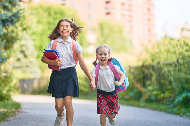 istock Girls with backpack are going to school 1166424080