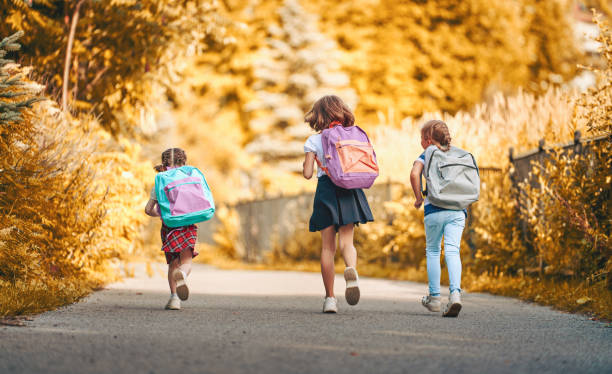 istock Girls with backpack are going to school 1166424091