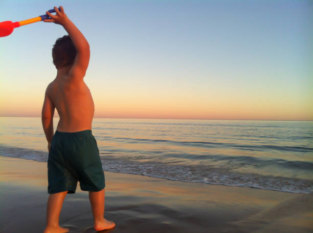 istock Boy playing in the sand of Pinamar beach 1166424163
