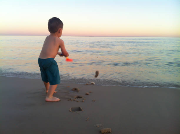 istock Boy playing in the sand of Pinamar beach 1166424252