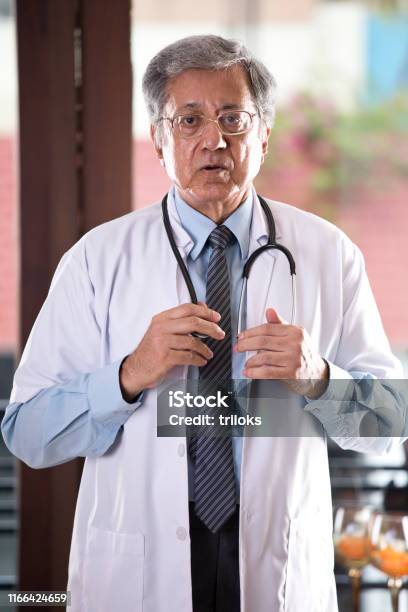 Senior Indian Doctor Looking At Camera Stock Photo - Download Image Now -  70-79 Years, Adult, Adults Only - iStock
