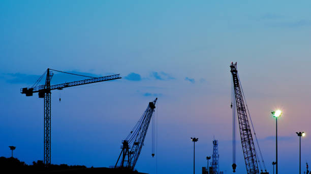 istock Silhouette industrial crane at harbor. 1166425539
