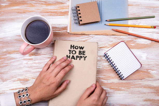 istock How to be happy. Hands holding book 1166425627